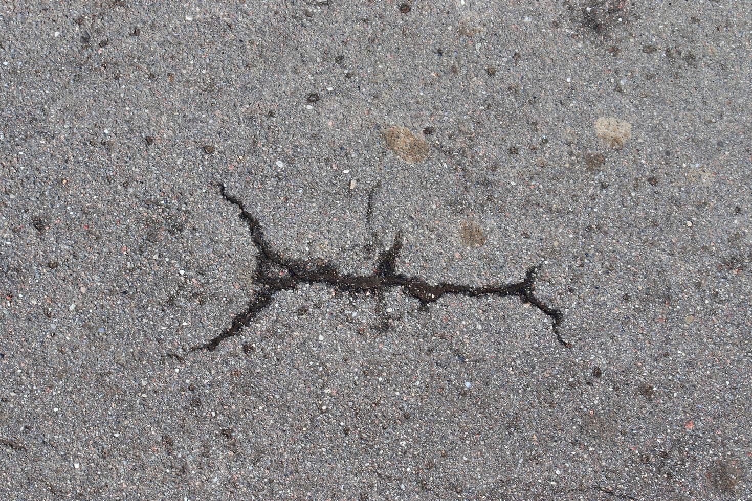 Detailed view on asphalt surfaces of different streets and roads with cracks photo