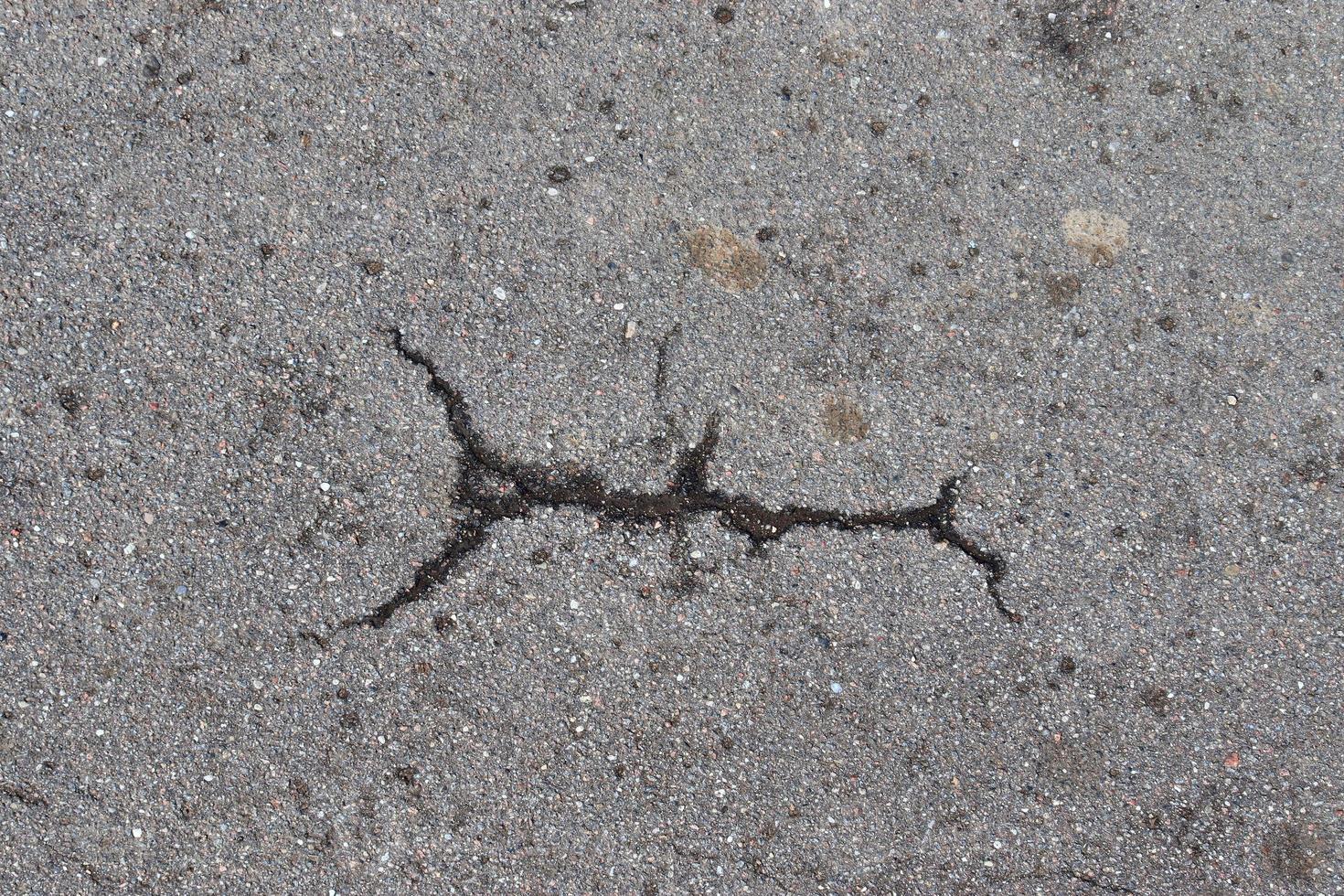 Detailed view on asphalt surfaces of different streets and roads with cracks photo