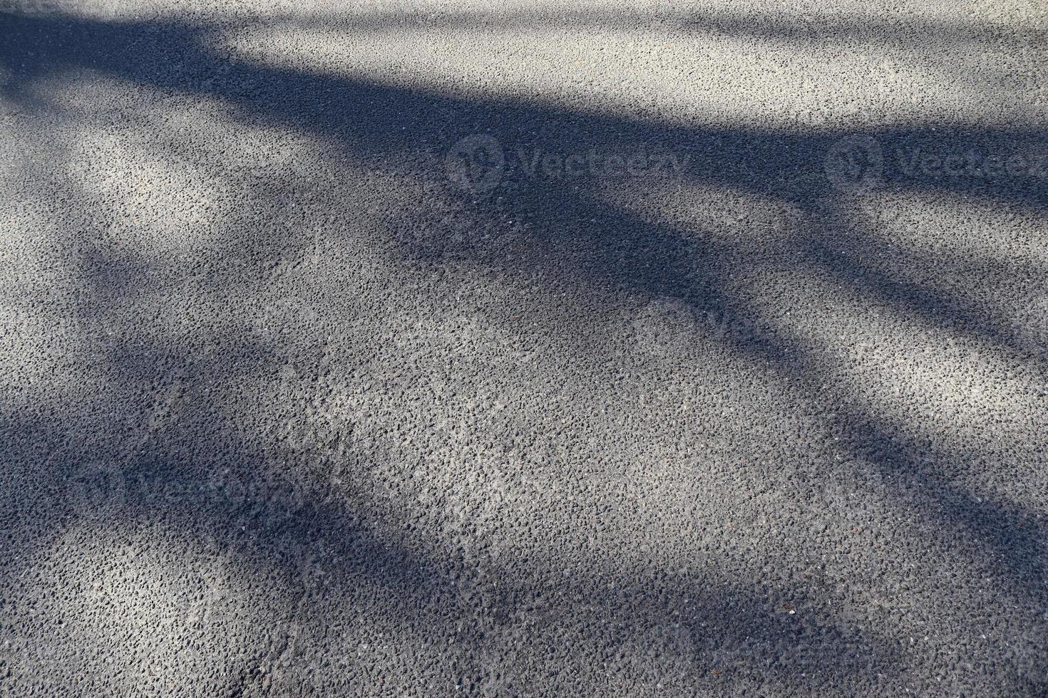 Detailed view on asphalt surfaces of different streets and roads with cracks photo