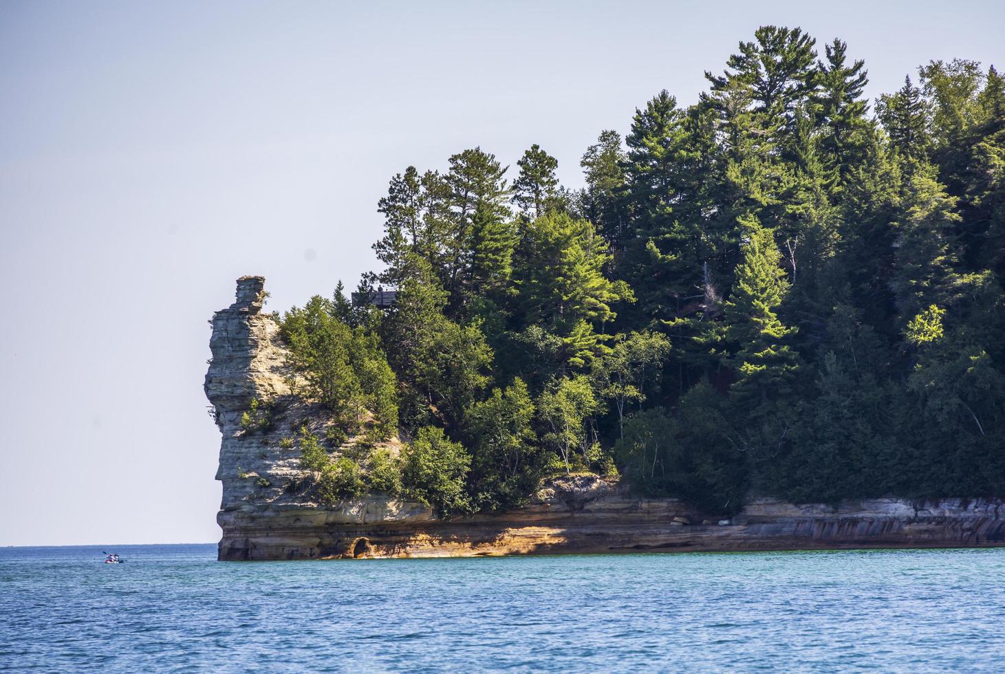 Colorful stone rocks on the edge of a lake in the summer photo