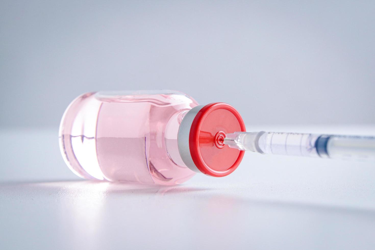 Anti-virus vaccine bottle with syringe Placed on a white background Concept of vaccine for the coronavirus, or COVID-19. Hospital medical services. photo