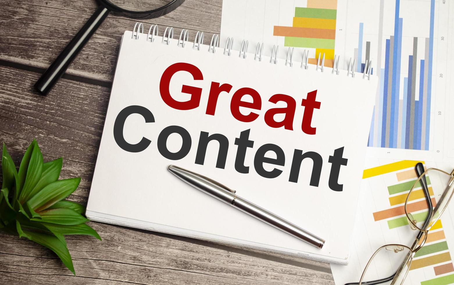 notepad ,chart and calculator. Top view text GREAT CONTENT photo
