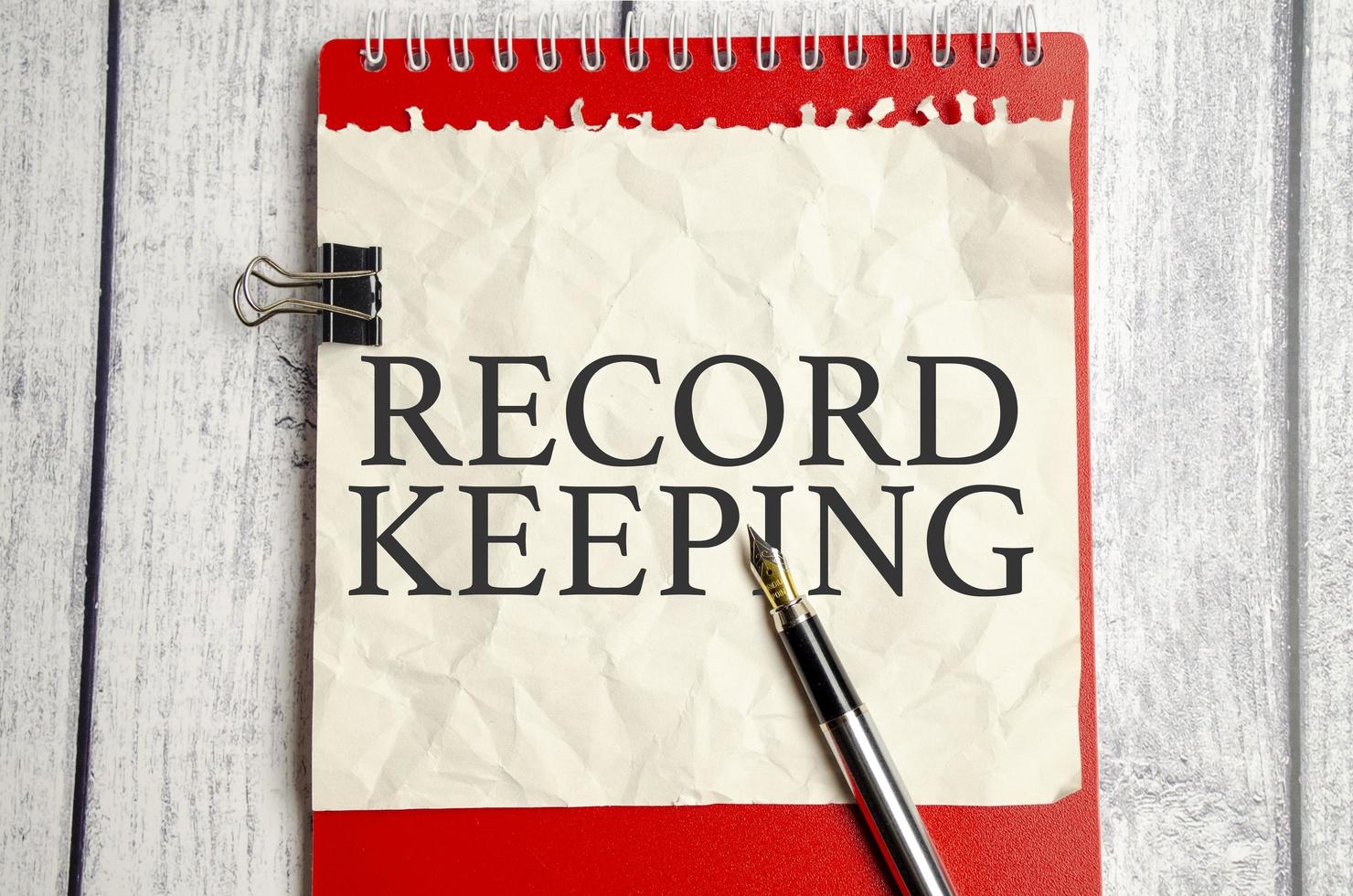 RECORD KEEPING text written on paper folder and charts photo