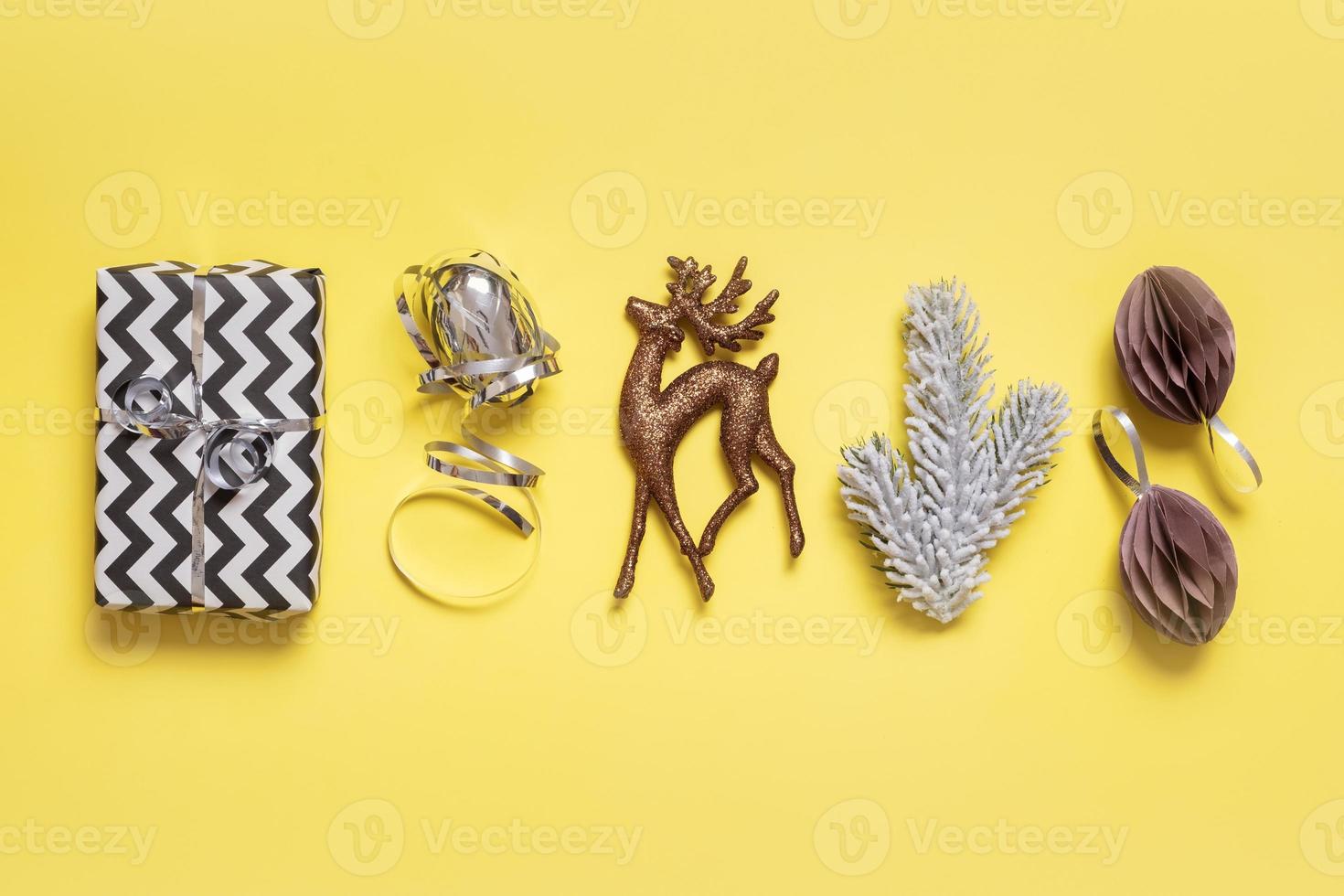 Festive minimal creative christmas composition with gifts and decorations flat lay on colored background photo