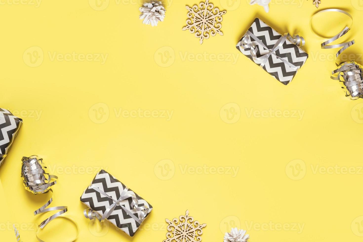 christmas flat lay composition from gift boxes, pine, cones on colored background top view. Copy space photo