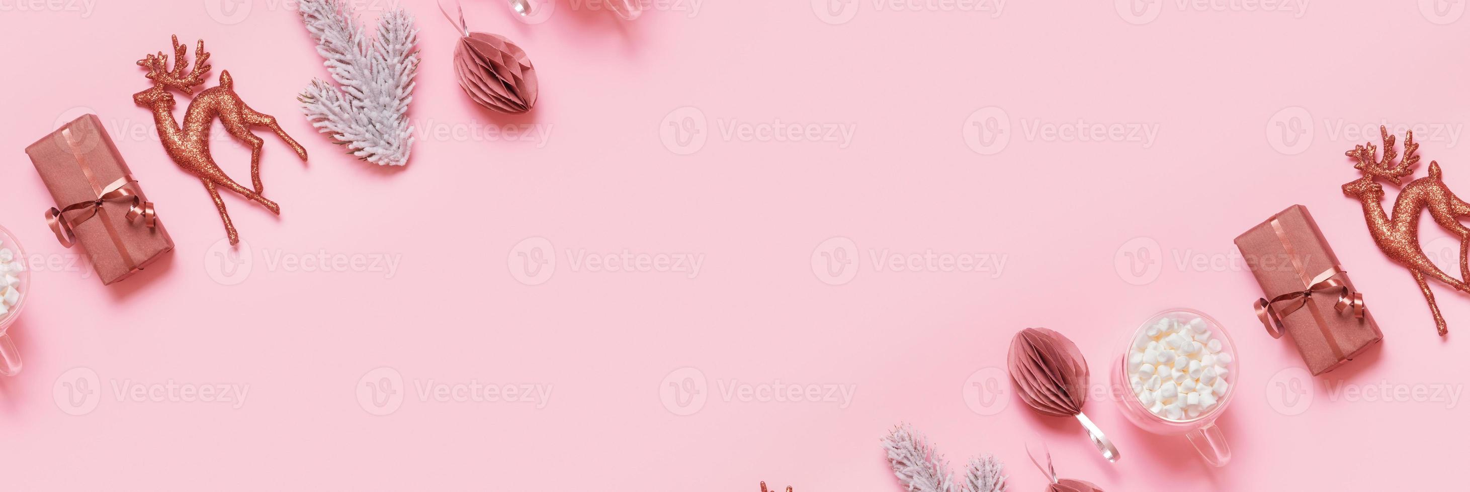 Banner with festive minimal creative christmas composition with gift, pine, deer and decorations flat lay on colored background photo