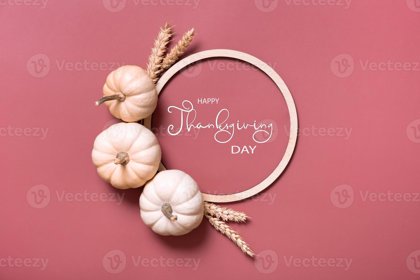 Happy thanksgiving day greeting card with decorative pumpkins and wooden frame top view, flat lay photo