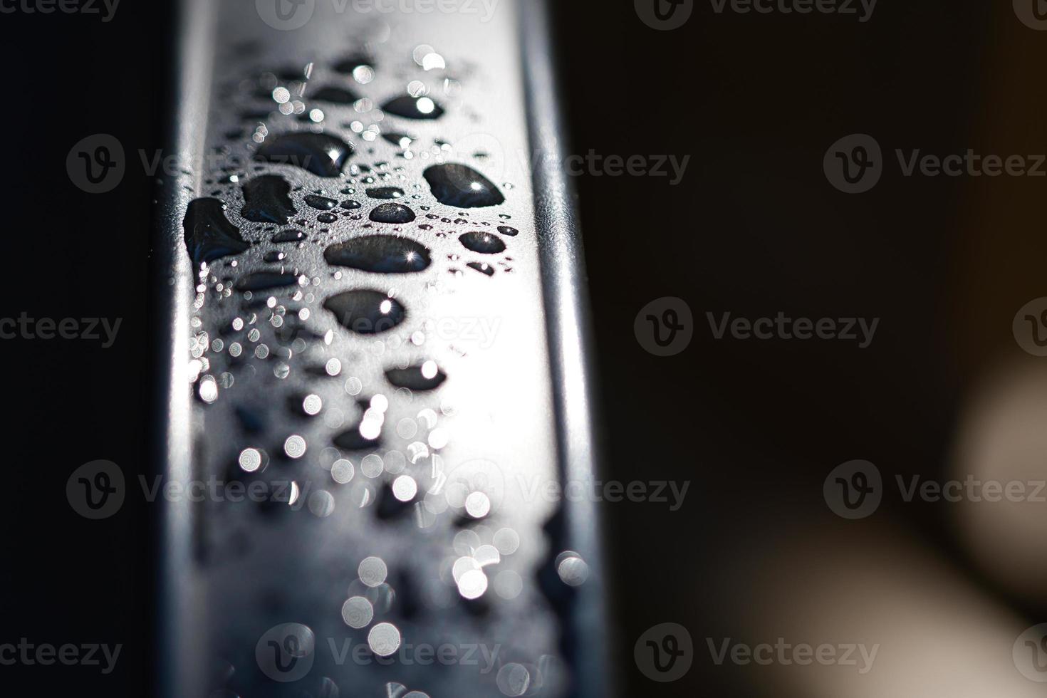 Water drops Abstract and with blurred background shines on a metal surface of a chair photo