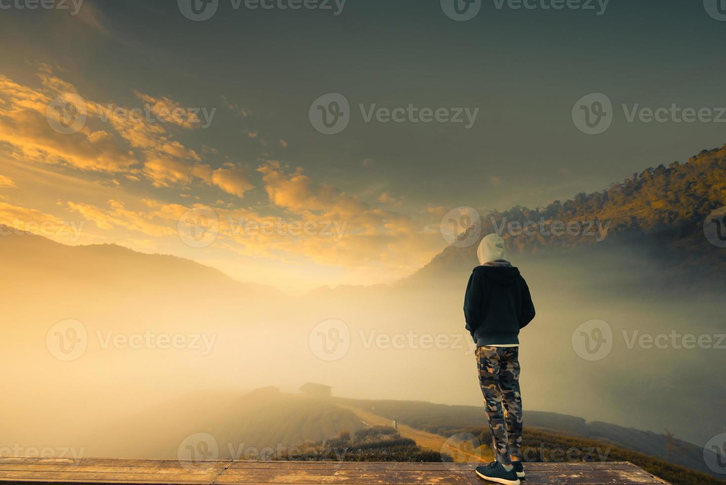 A man stand in the Beautiful landscape of green tea plantation in the morning. 2000 Tea plantation, Doi Angkhang mountain, Chiangmai, Thailand photo