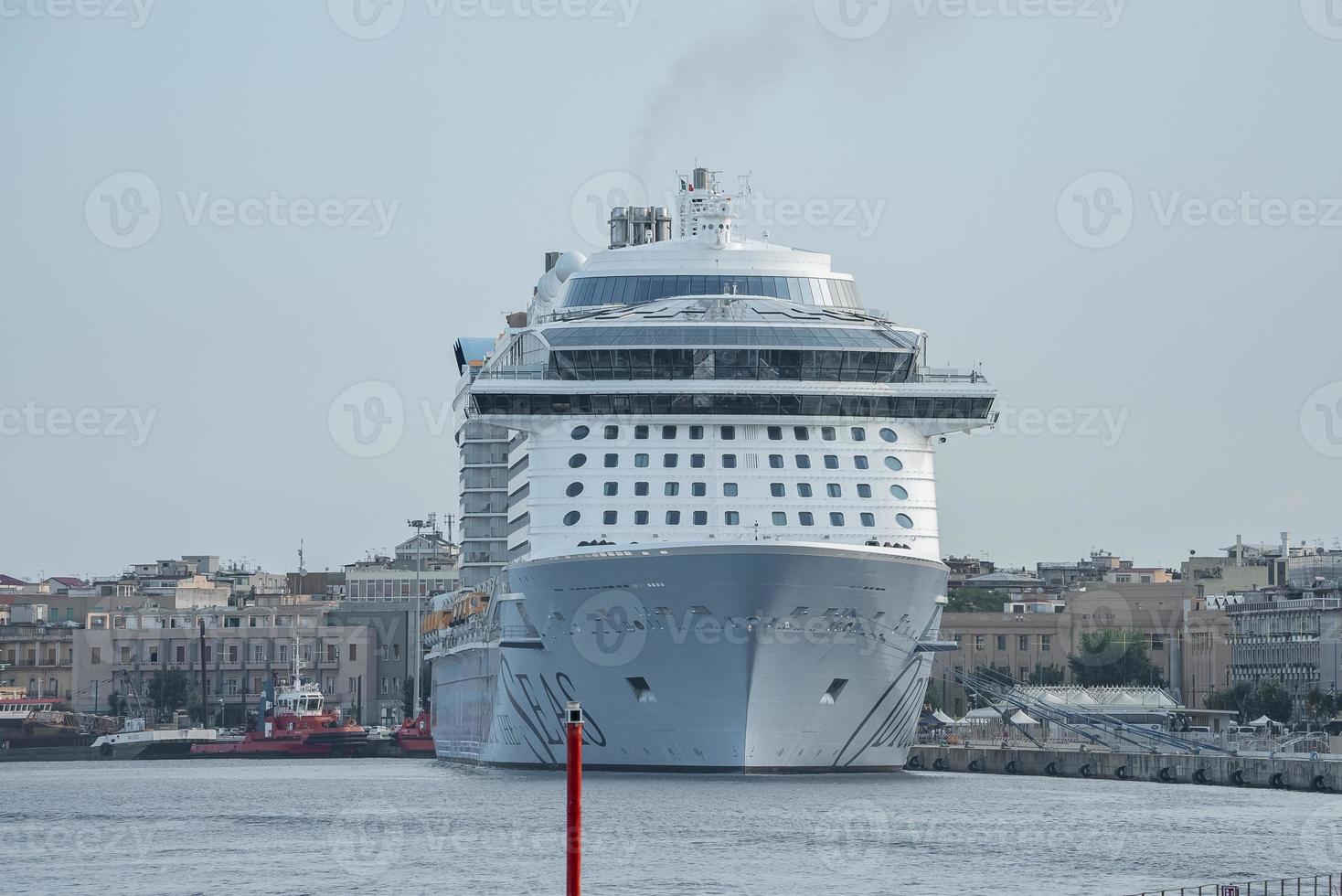 View of majestic cruise ship moored at Messina harbor with sky in background photo