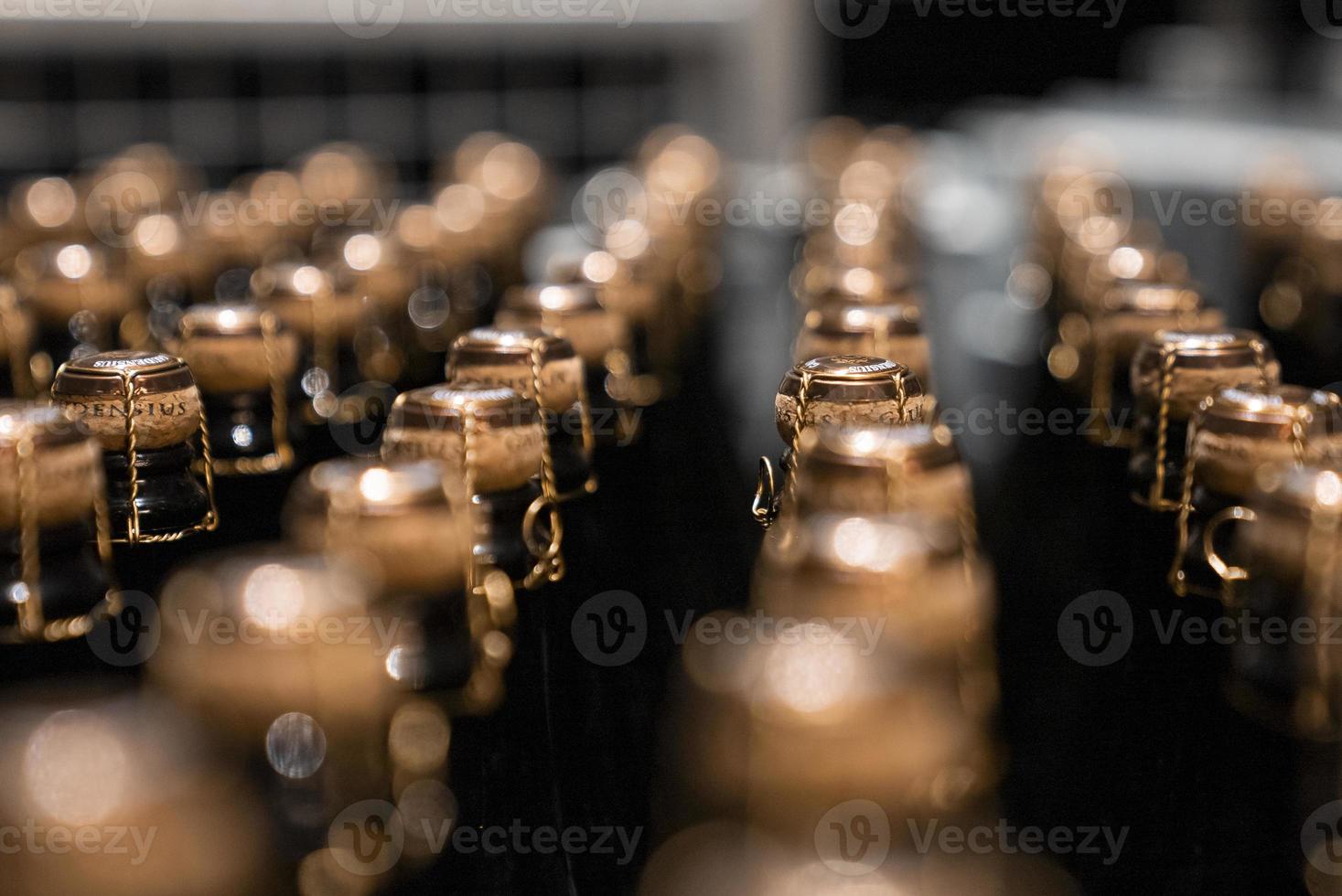 Close-up of packaged wine glass bottles arranged in storage container at winery photo