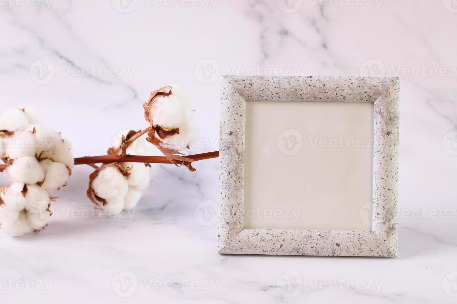 Photo frame mock up marble texture, cotton flower