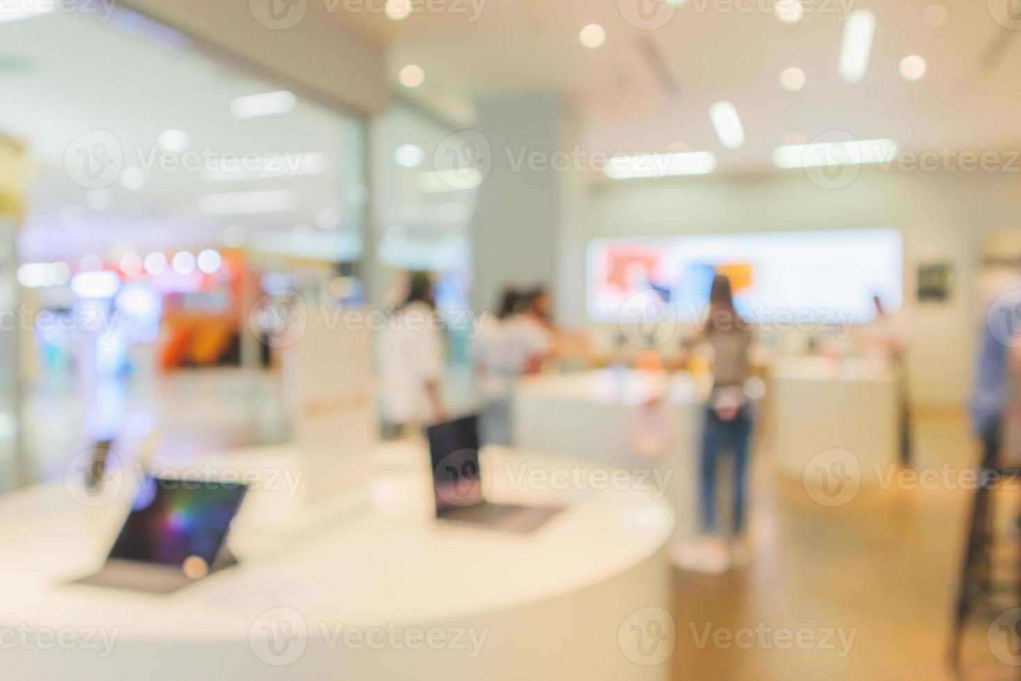 mobile phone in electronic store interior with customer abstract blurred background photo