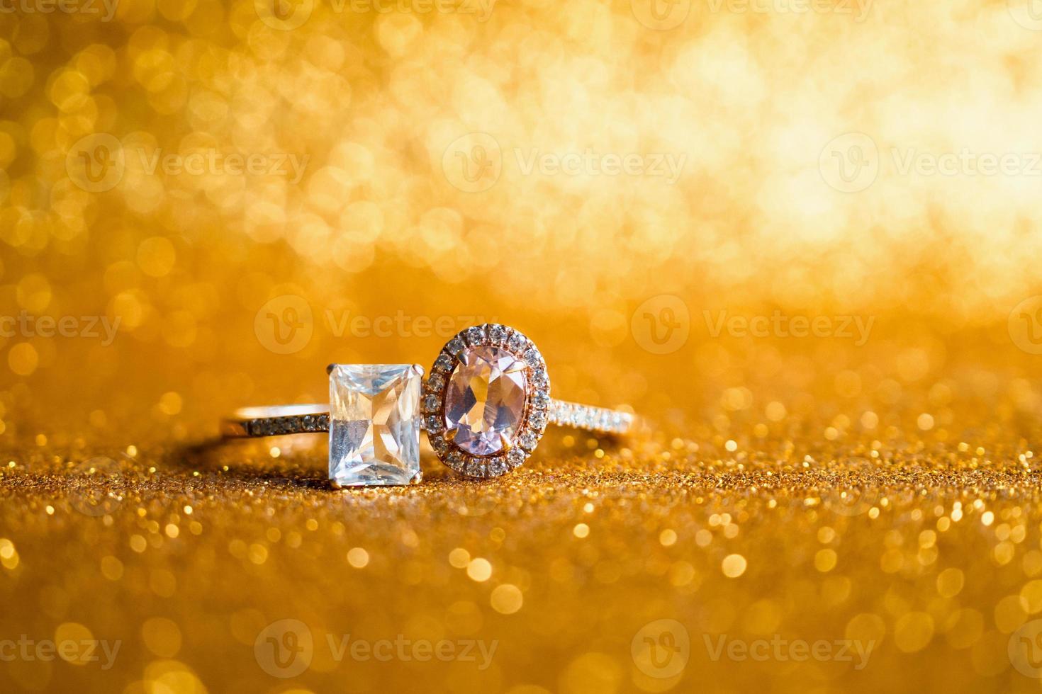 Jewelry diamond ring with abstract festive glitter Christmas holiday texture background blur with bokeh light photo