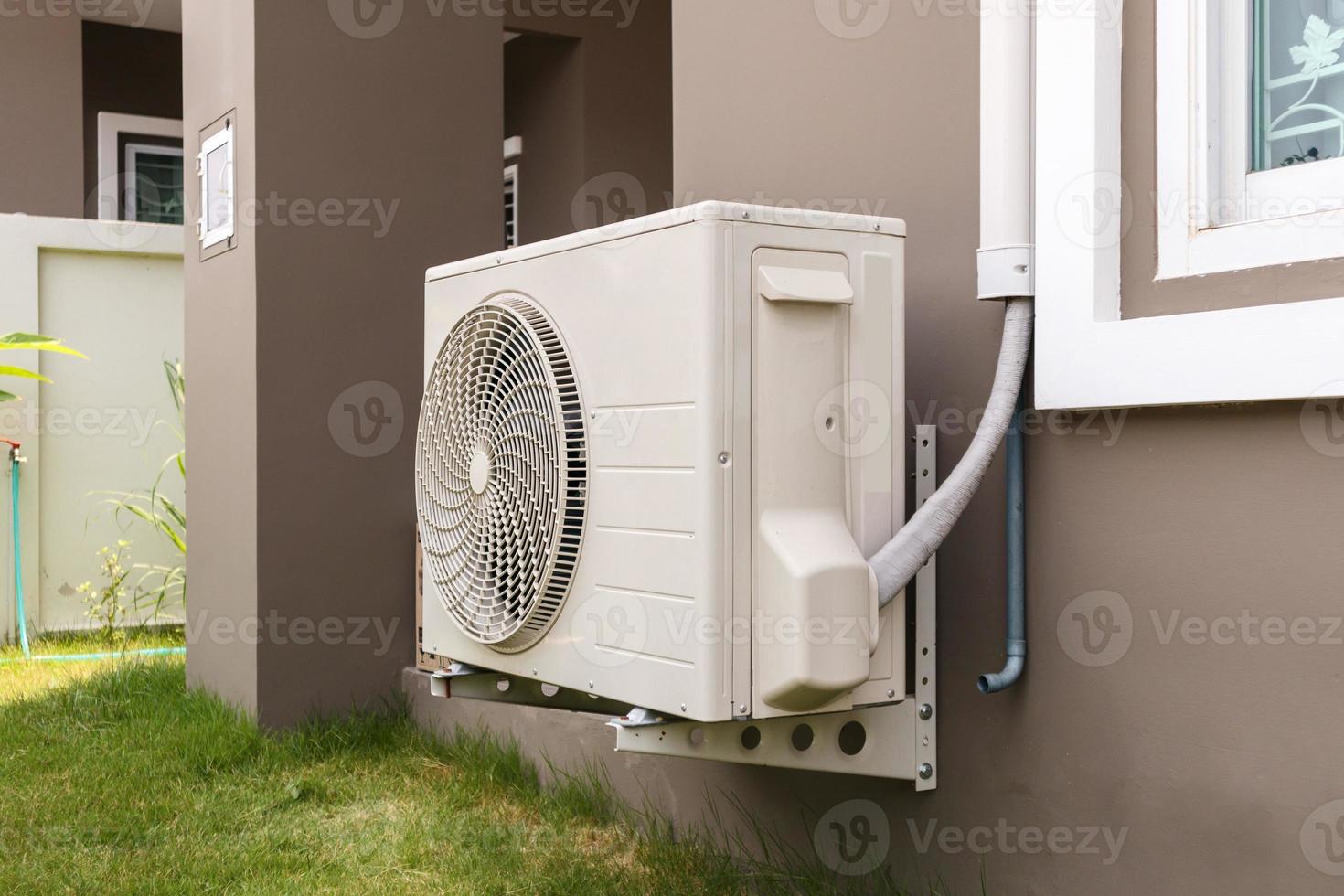 Air conditioner compressor outdoor unit installed outside the house photo