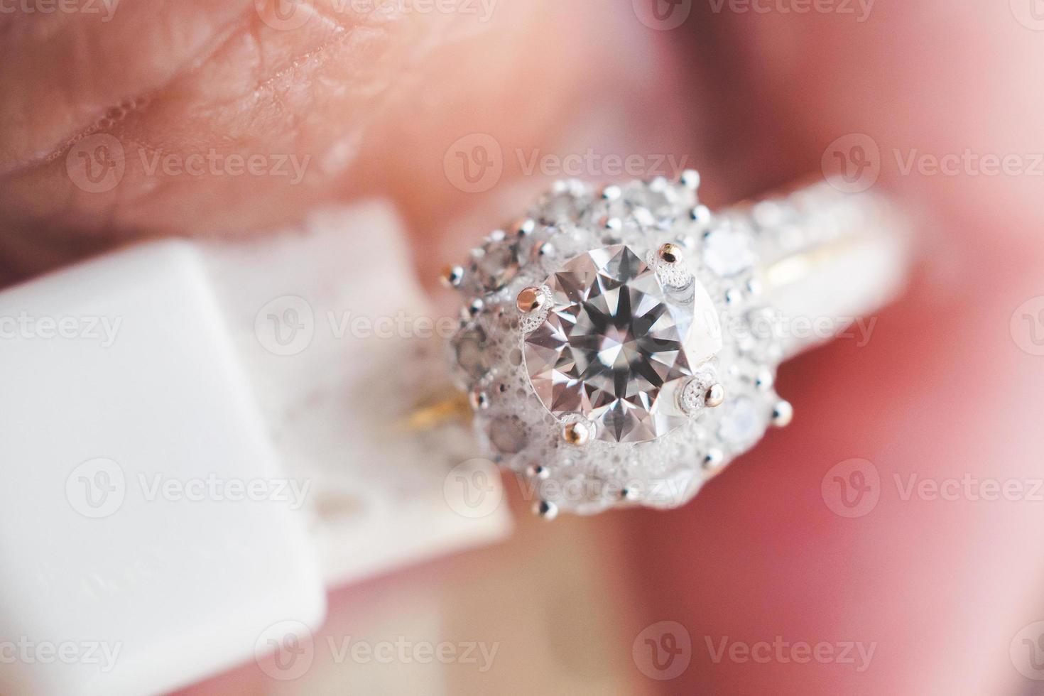 Jeweller hand cleaning and polishing vintage jewelry diamond ring closeup macro photo