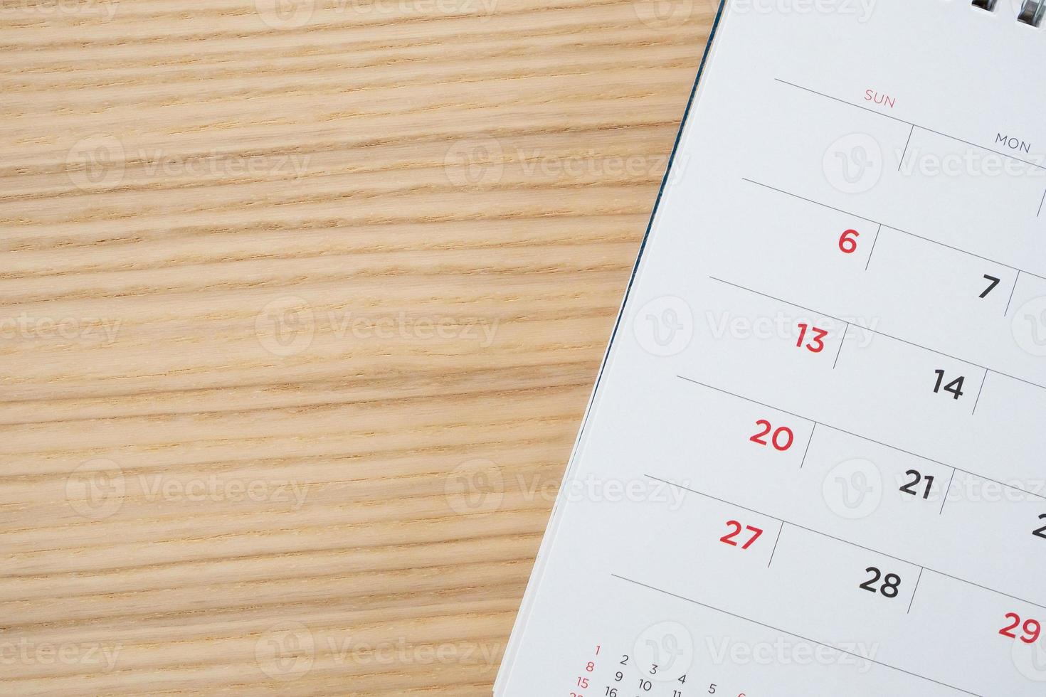 calendar page on wood table background photo