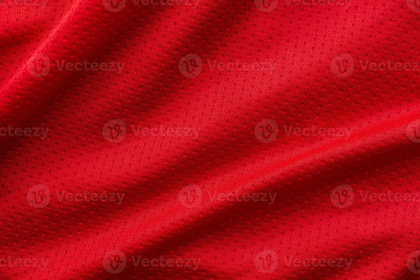 Red fabric sport clothing football jersey with air mesh texture background photo