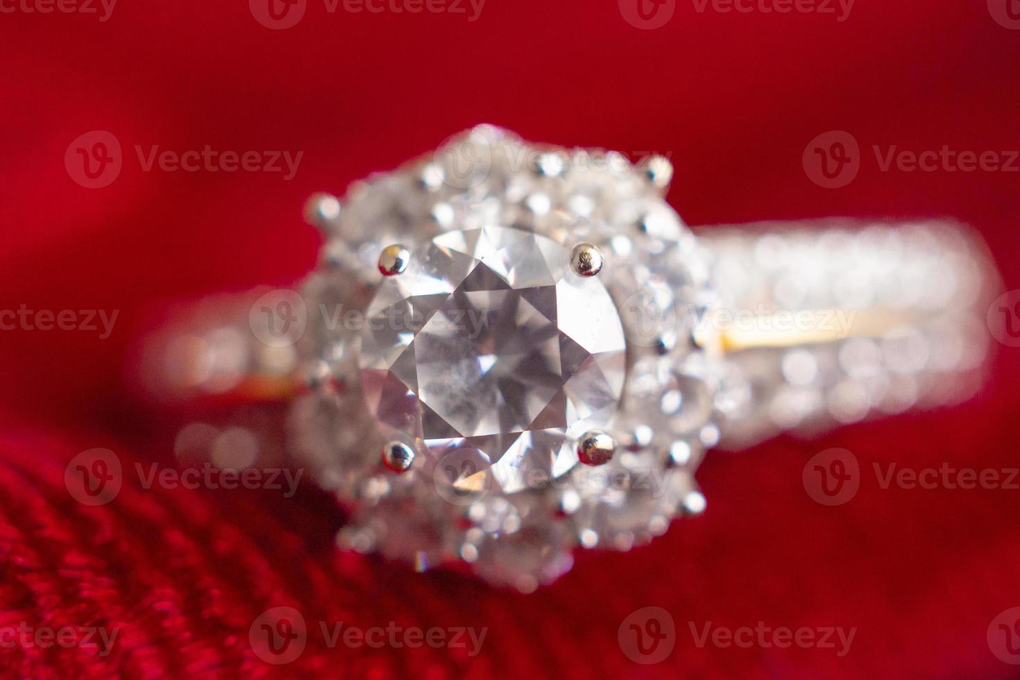 luxury jewelry diamond ring on red fabric background photo