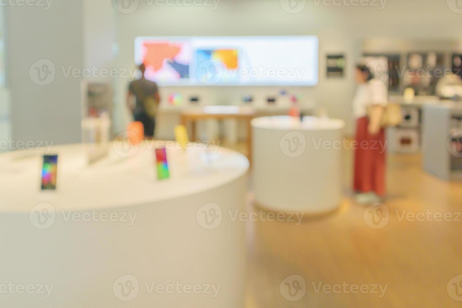 mobile phone in electronic store interior with customer abstract blurred background photo