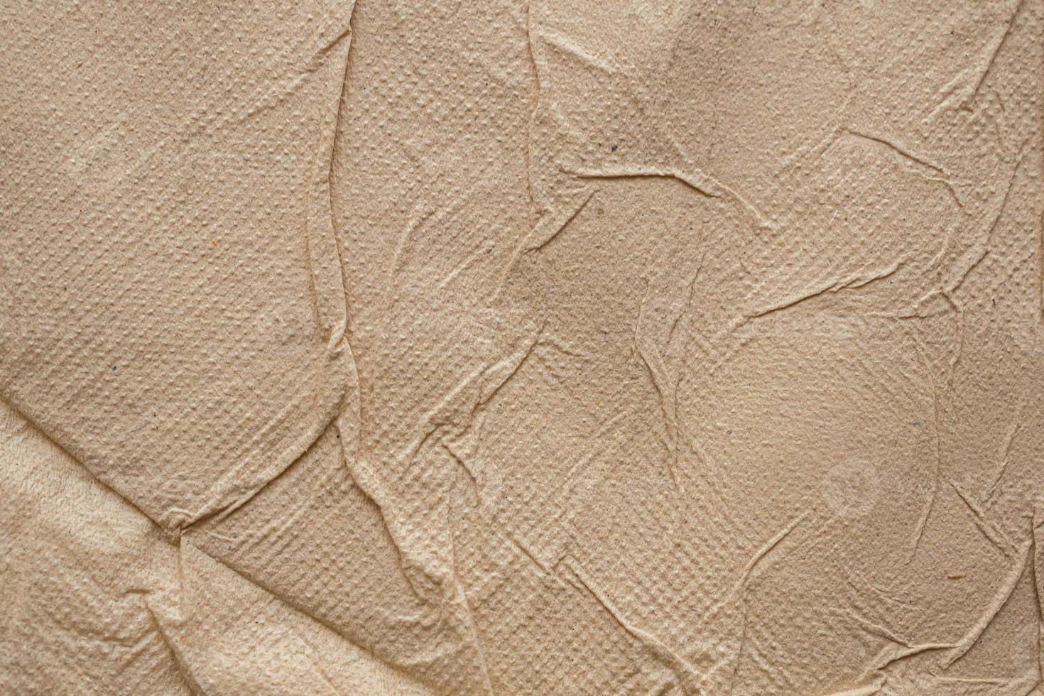 Crumpled brown recycle tissue paper texture abstract background photo