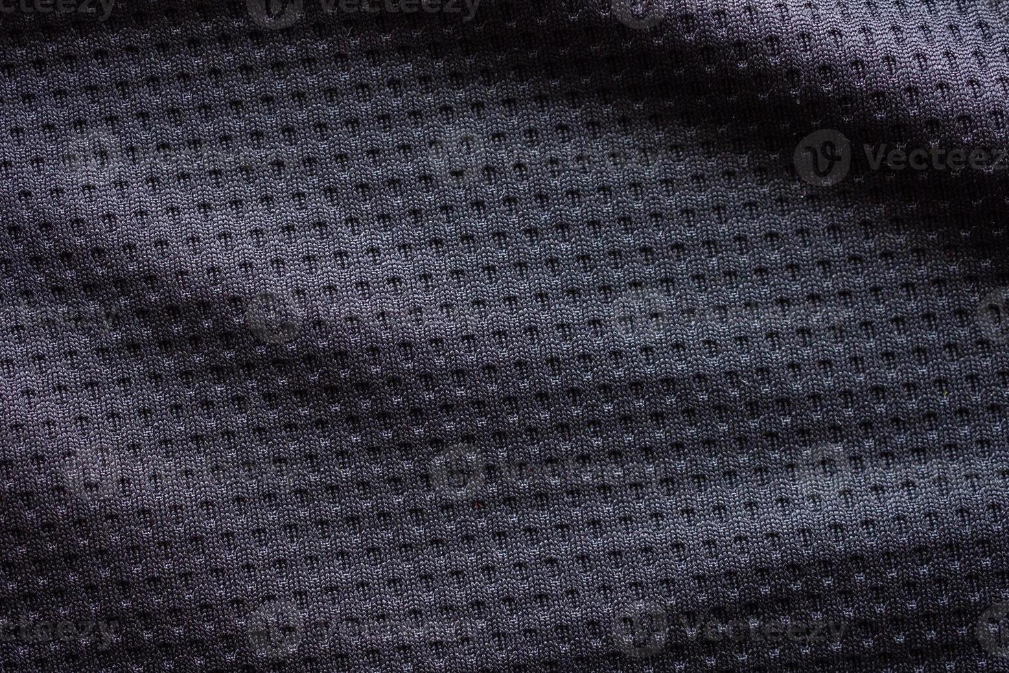 Black fabric sport clothing football jersey with air mesh texture background photo