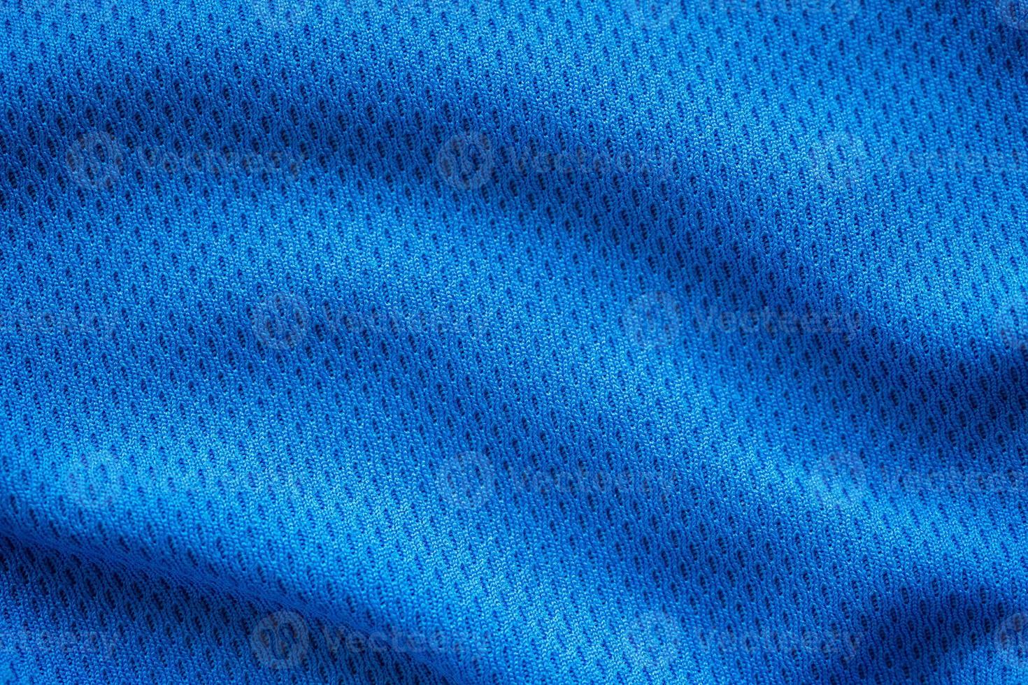 Blue fabric sport clothing football jersey with air mesh texture background photo