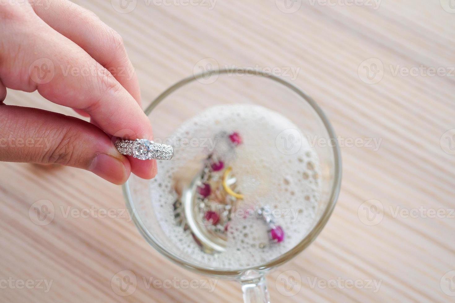 Jeweller hand cleaning vintage jewelry diamond ring closeup photo
