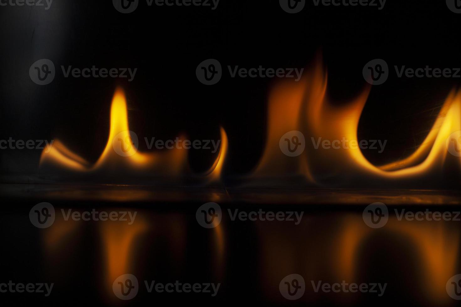 Flames in dark. Tongue of fire. Ignition of alcohol. Burning alcohol on black background. photo