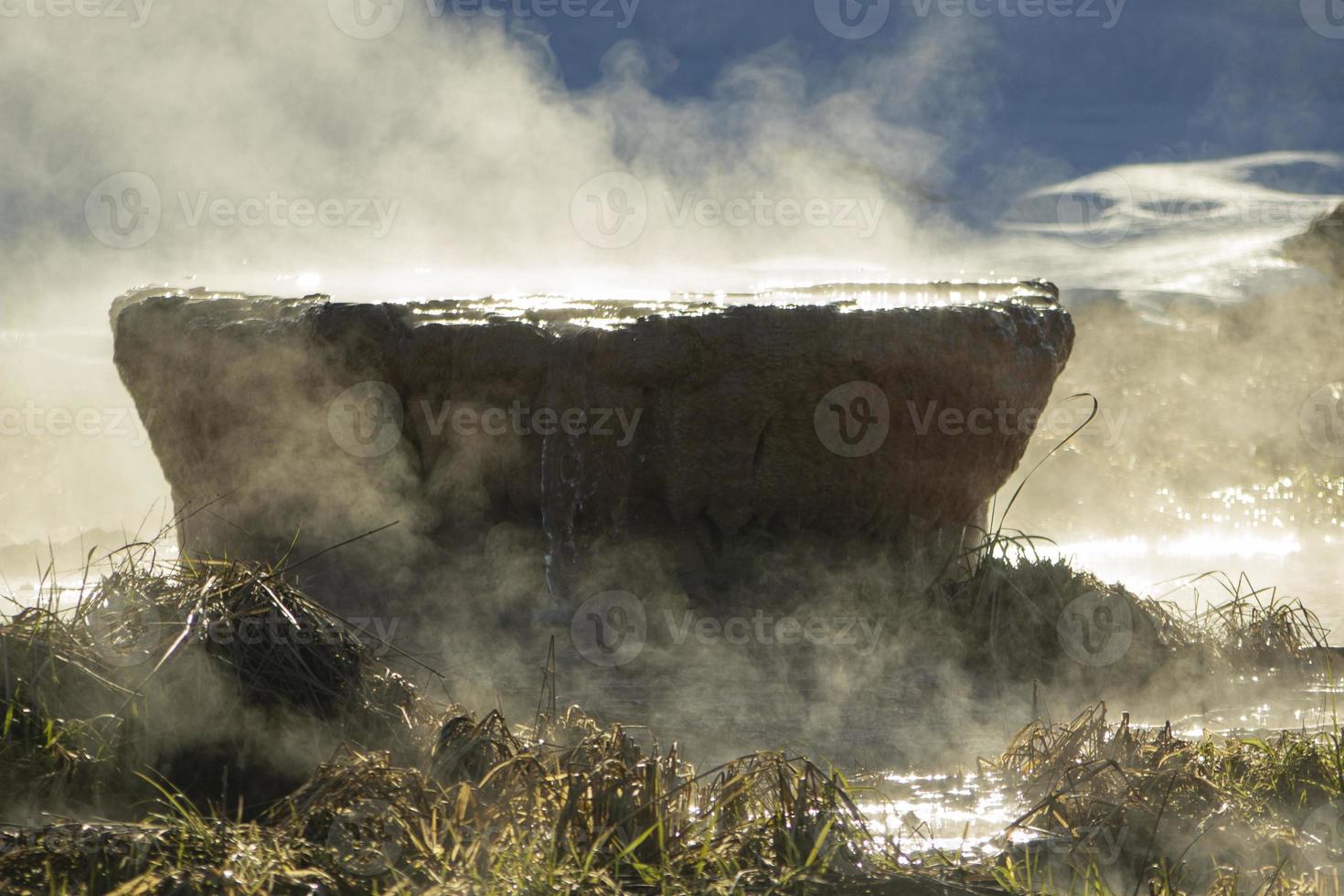 Pipe in lake. Steam over pipe. Production waste. Drain for water. photo