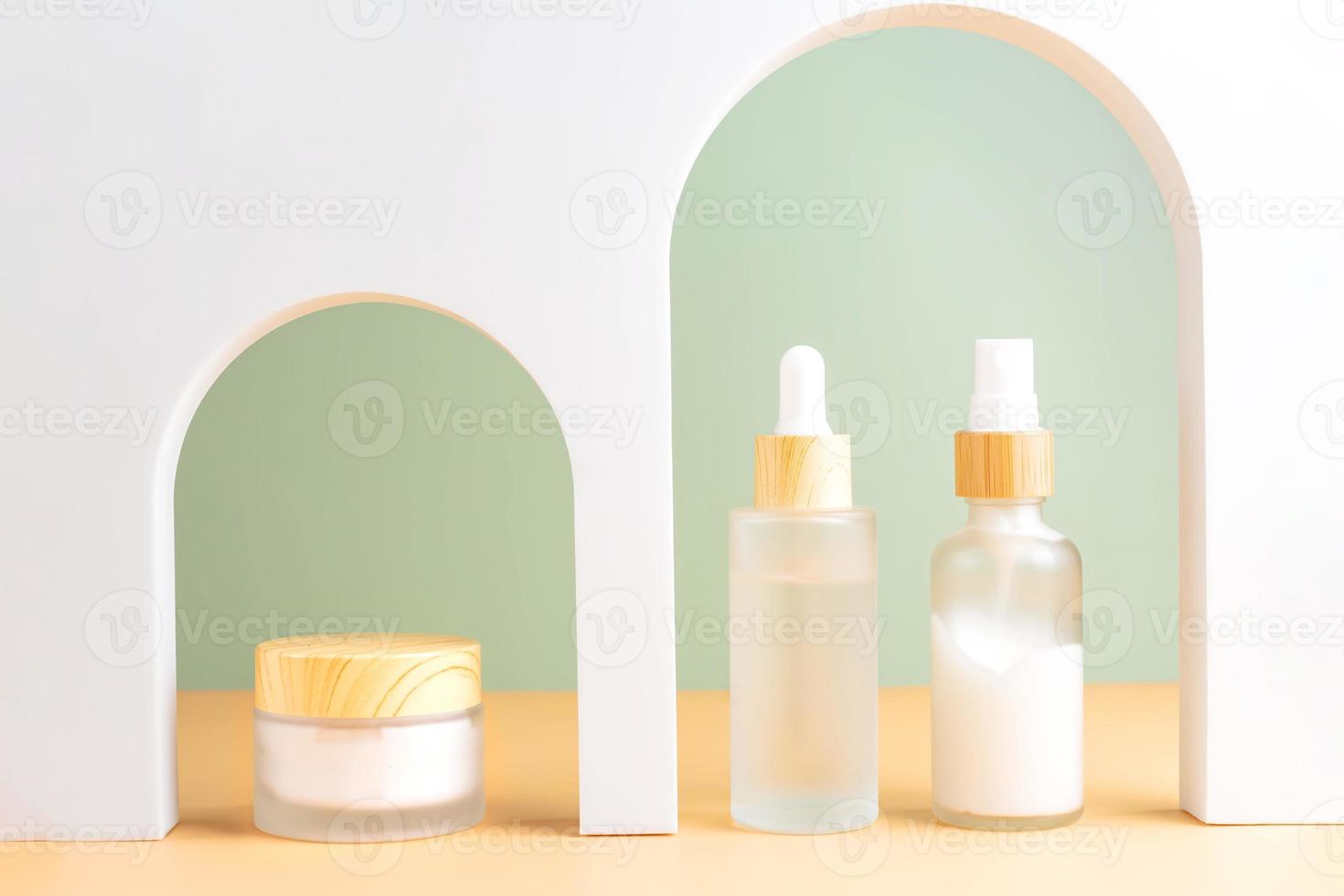 Various blank cosmetic container mock-ups on podiums and geometrical forms. Background for branding and packaging presentation. Natural skincare beauty product concept photo