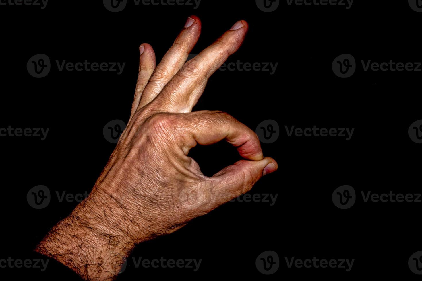 old man hand isolated on black ok sign photo