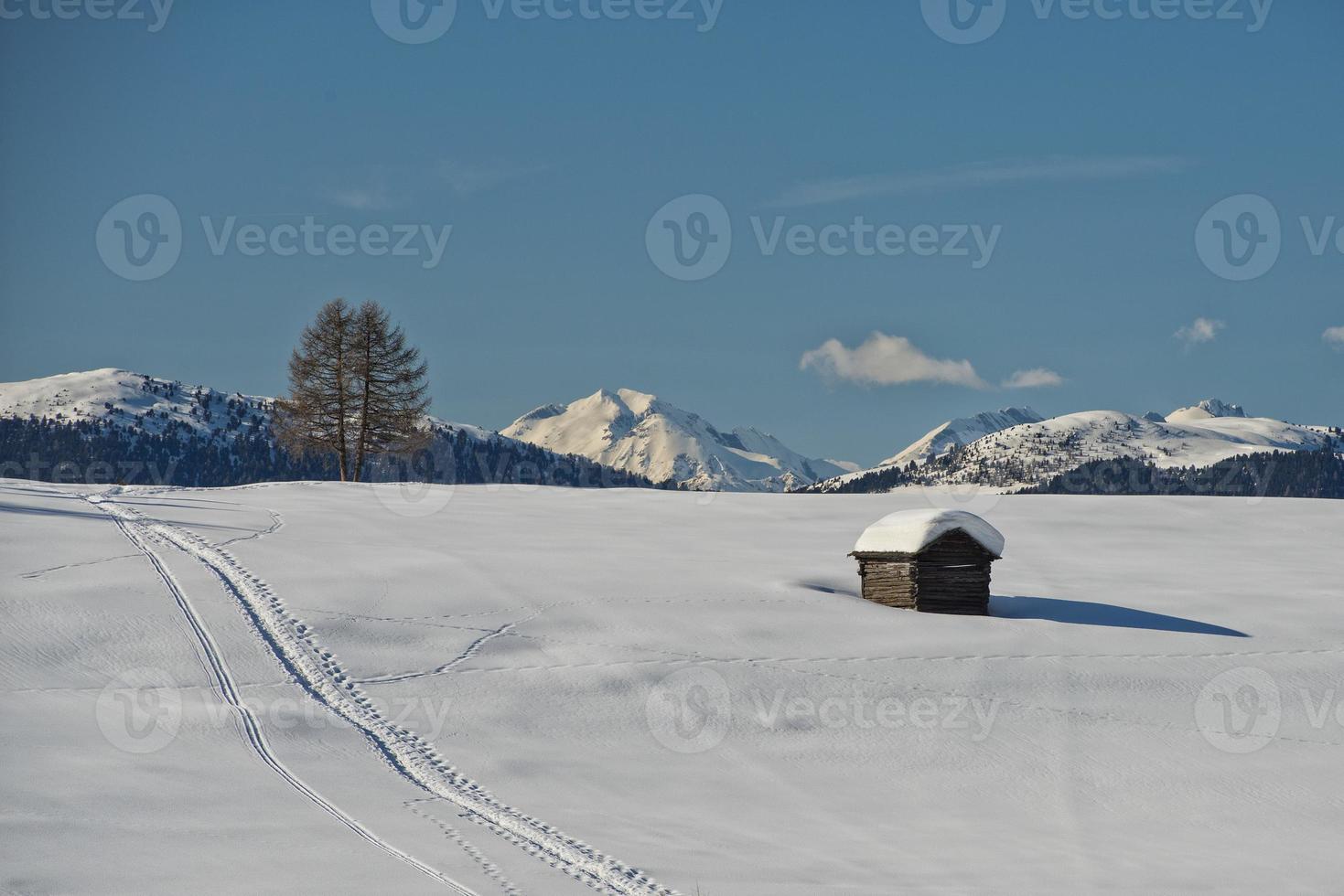 A wood cabin hut in the winter snow background photo