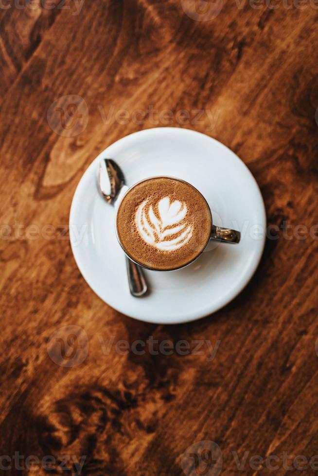 Cappuccino in White Ceramic Cup on White Ceramic Saucer photo