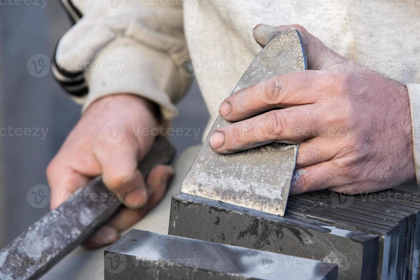 Old retired man hands working slate photo