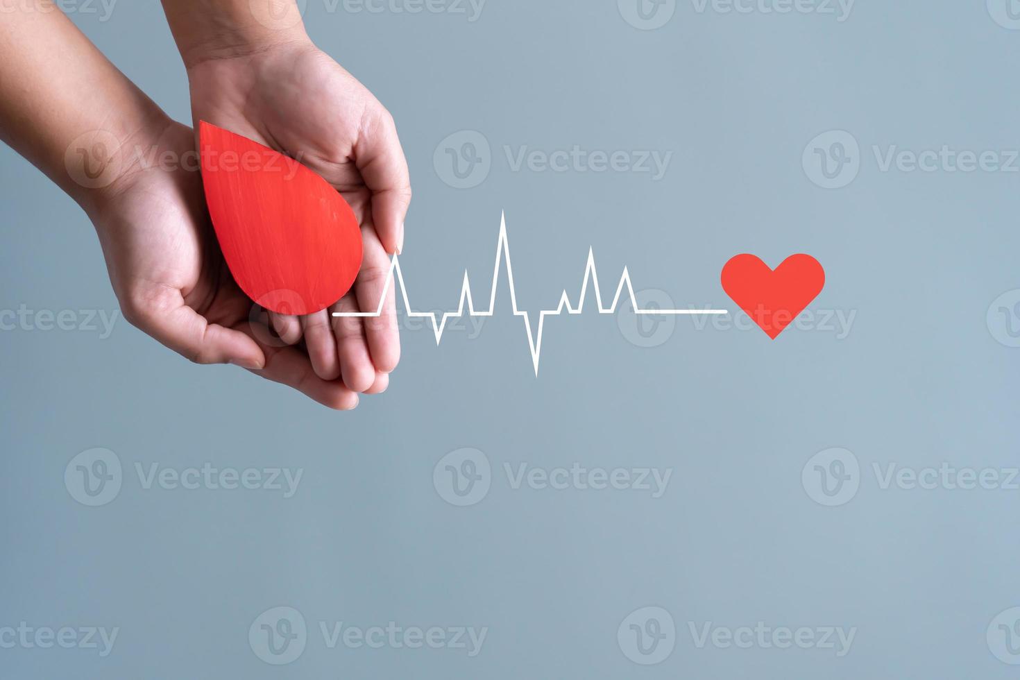 Blood donation concept. Human holding blood sign connecting by heart rate. photo