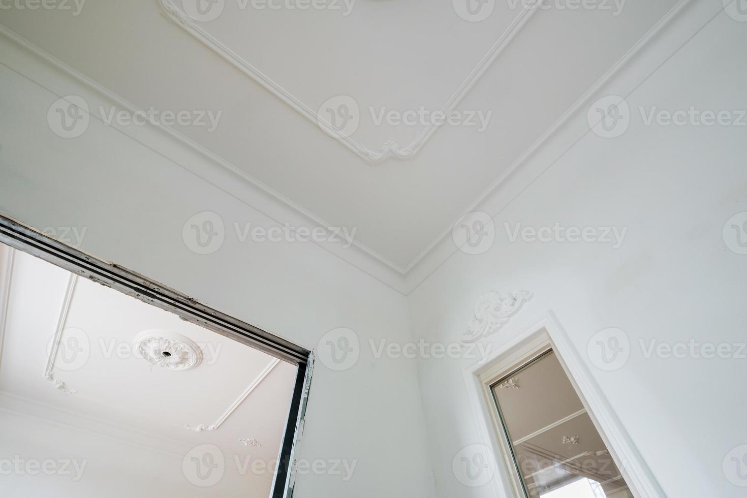 corner of ceiling cornice with intricate crown molding. photo