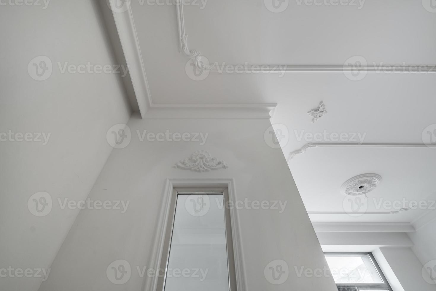 corner of ceiling cornice with intricate crown molding. photo