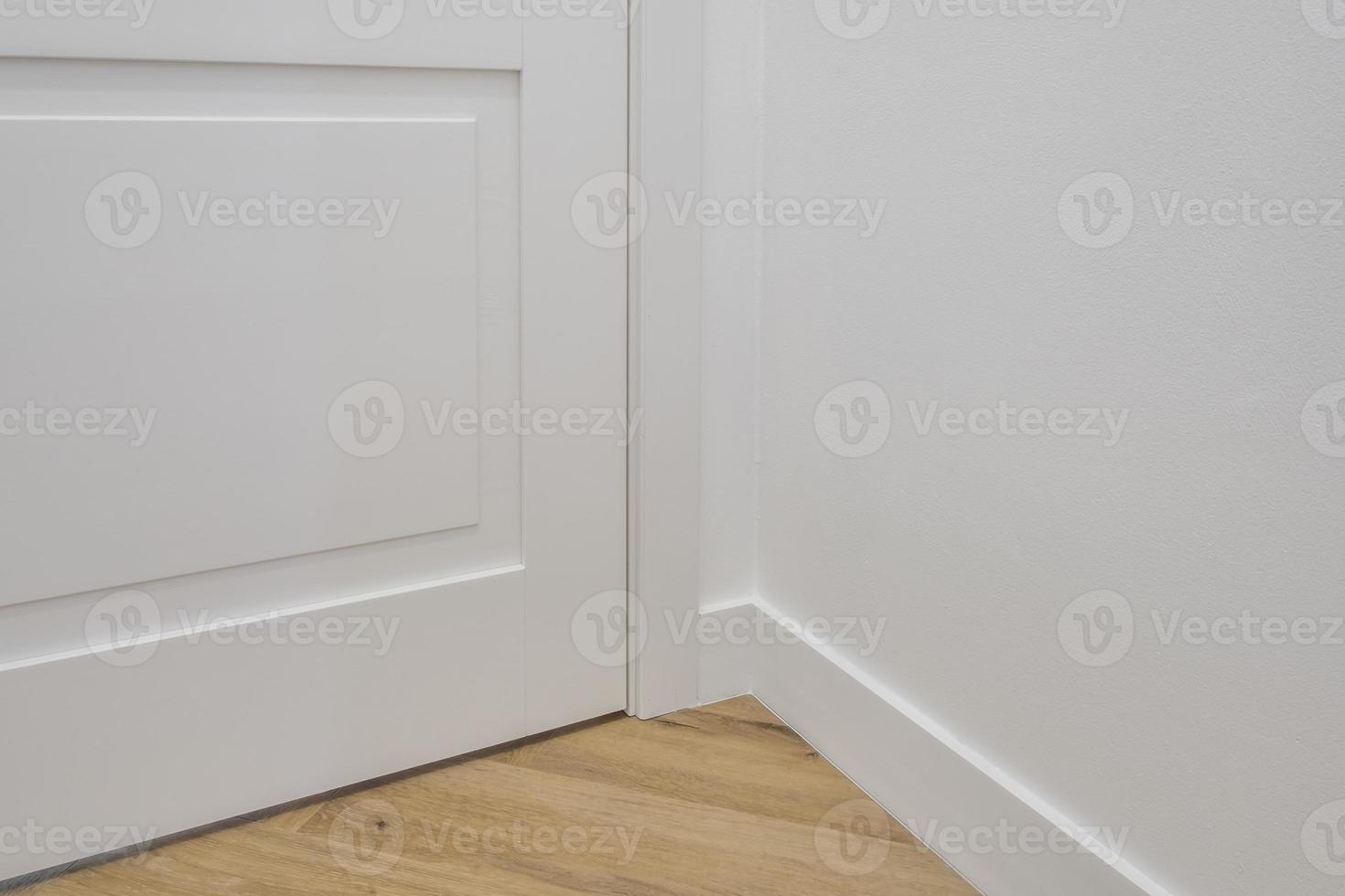 Detail of corner flooring with intricate crown molding and plinth. photo