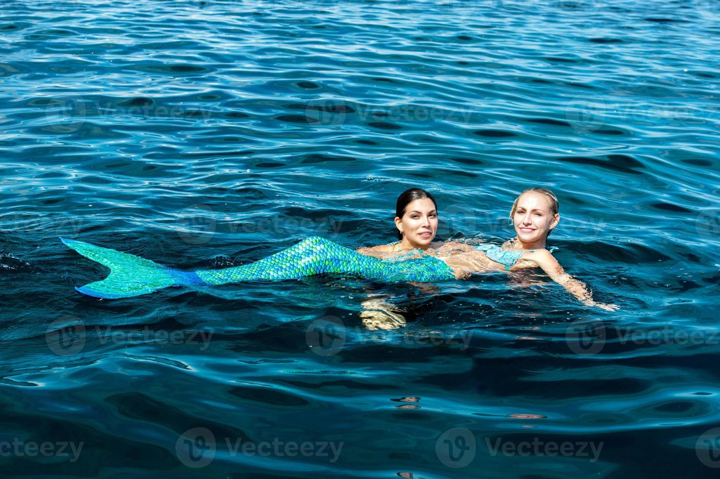 Mexican latina beauty and Blonde beautiful Mermaid photo
