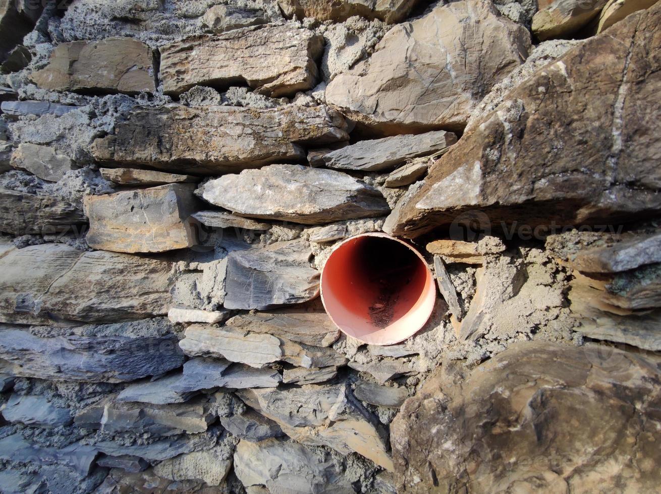 medieval wall of alley of Sant Ilario Genoa Italy with new water pipe photo