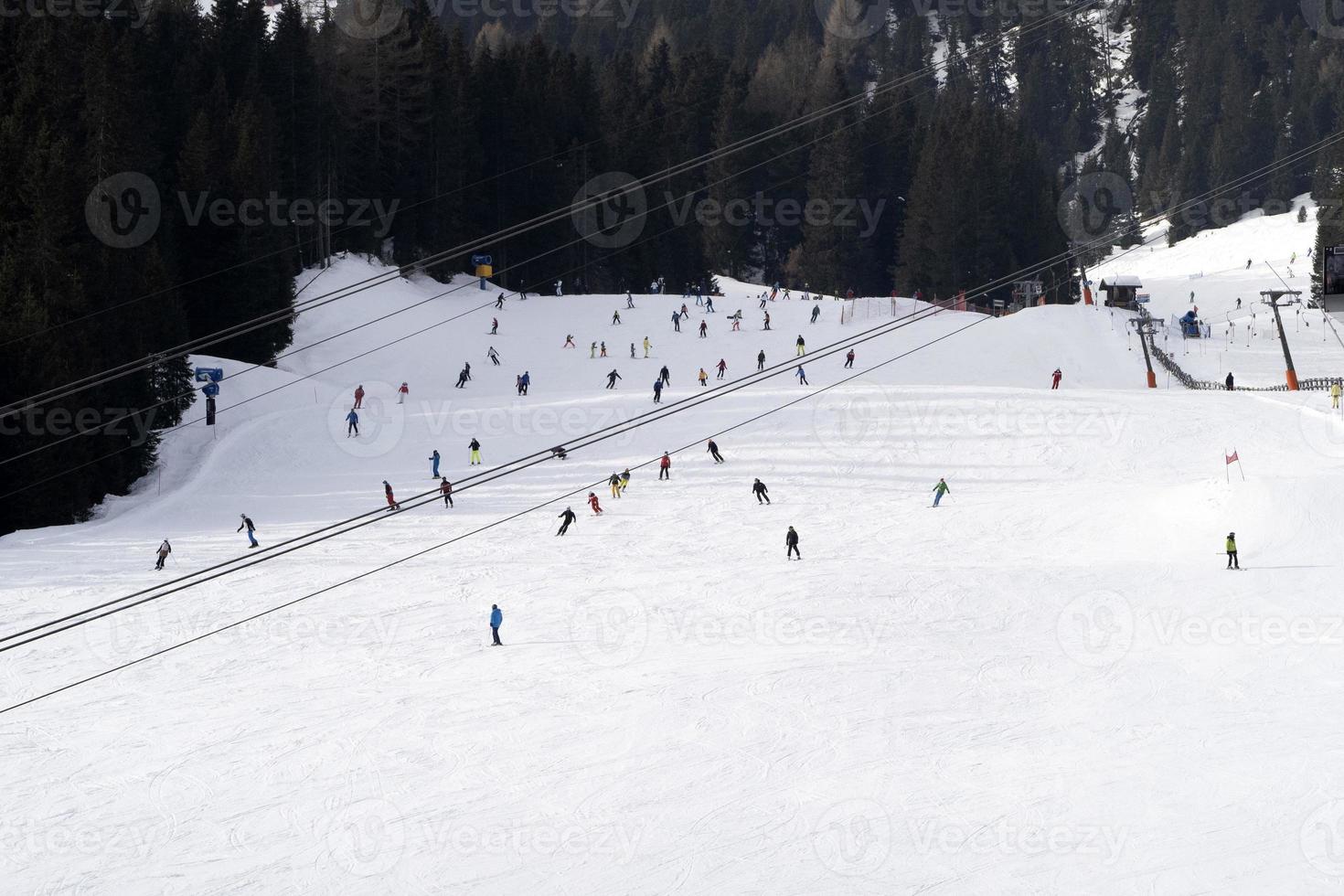 many skiers skiing in dolomites gardena valley snow mountains photo