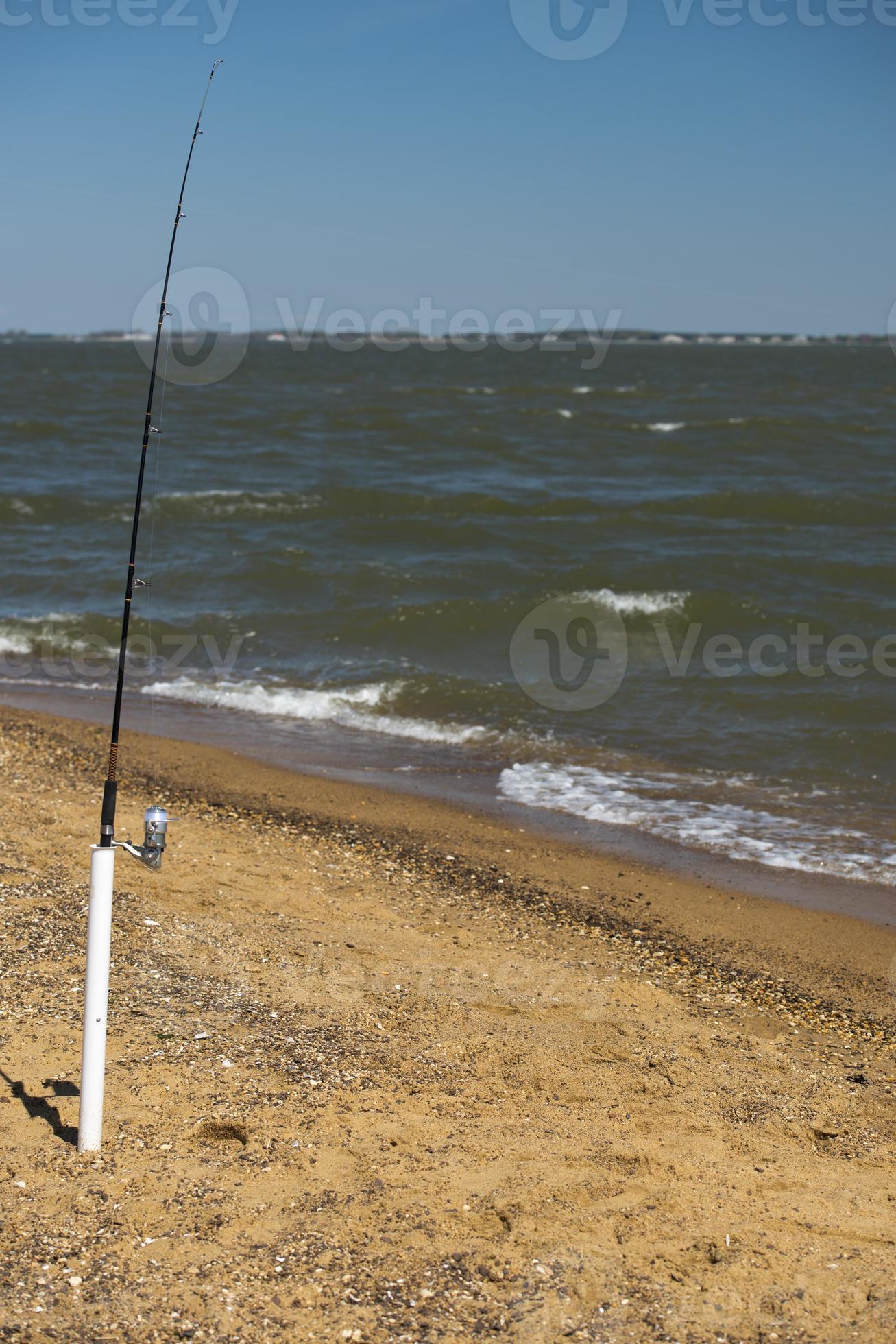 fishing pole on the beach 12208574 Stock Photo at Vecteezy