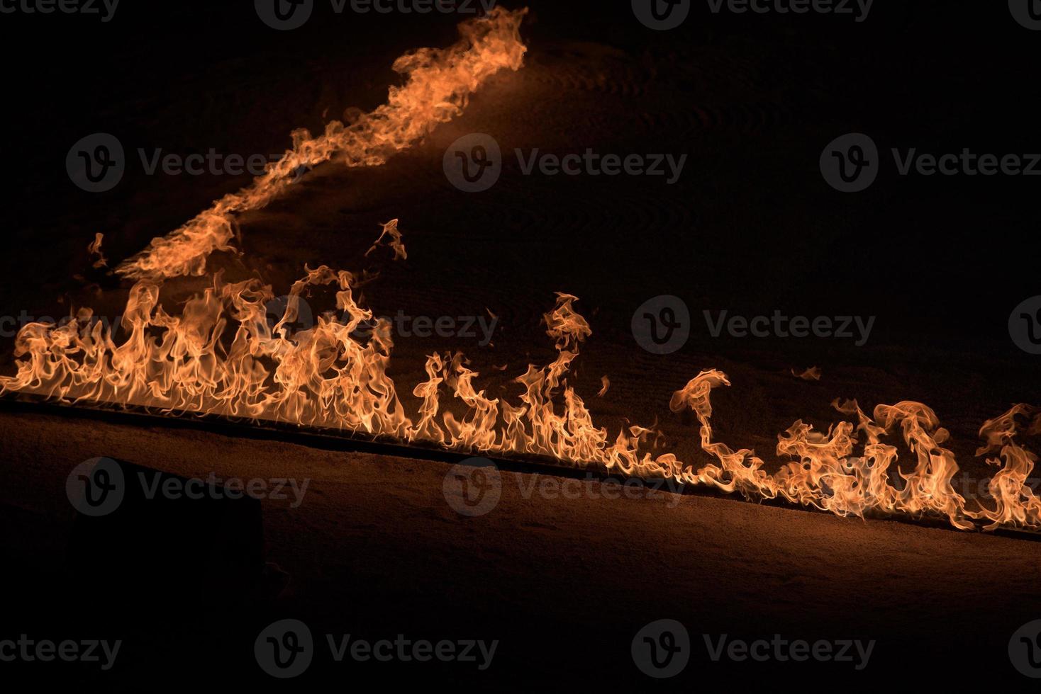 Orange Flames on black background photo