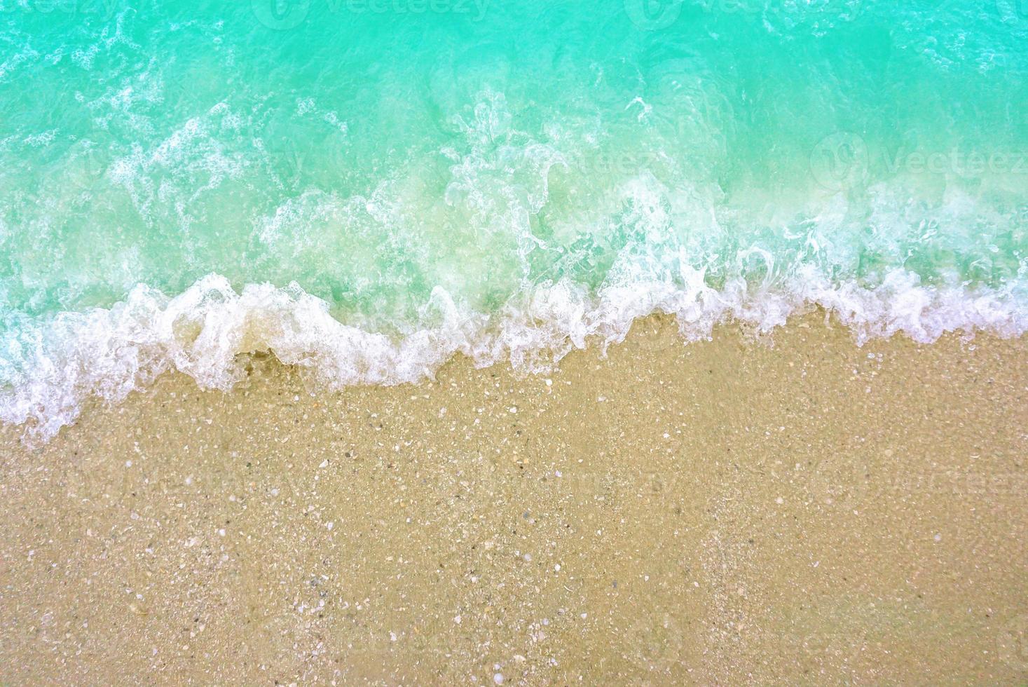 The light wave and beautiful green sea with space for texts on the beach background.. photo