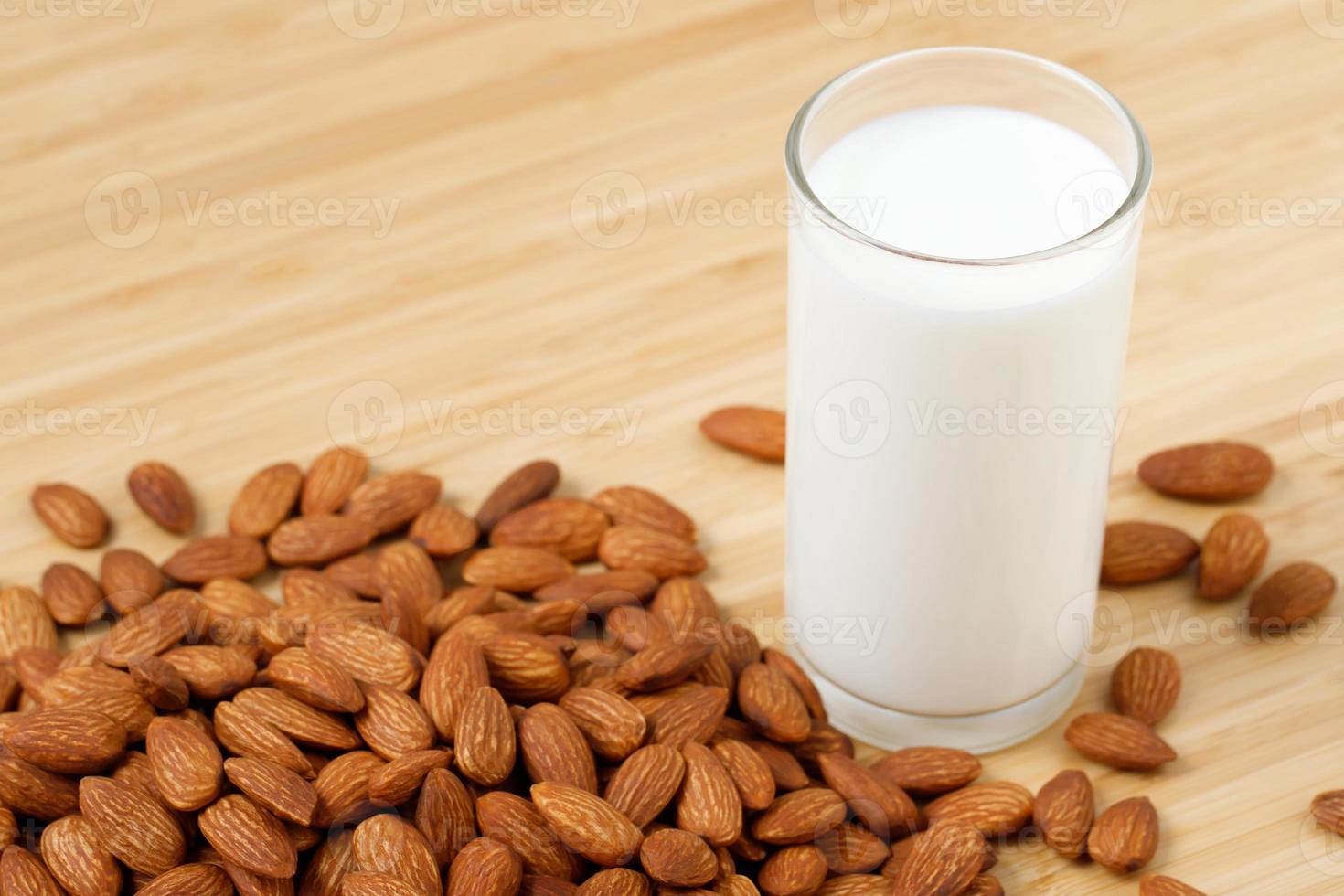 Almond milk in glass with almonds photo