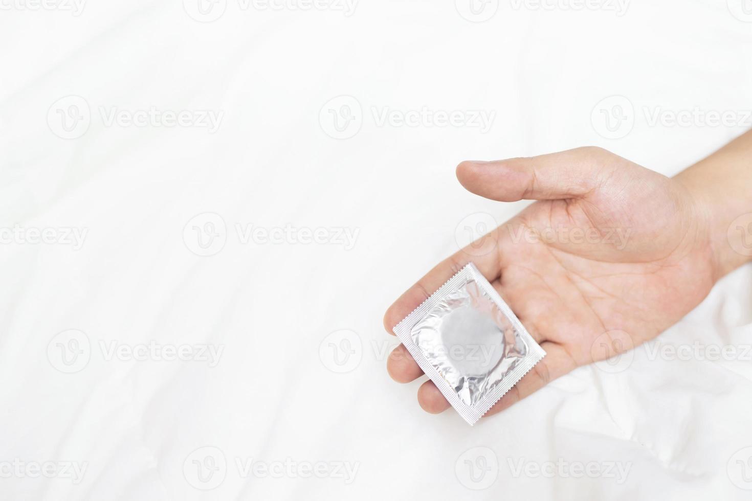 Men use condoms to prevent the AIDS virus. photo