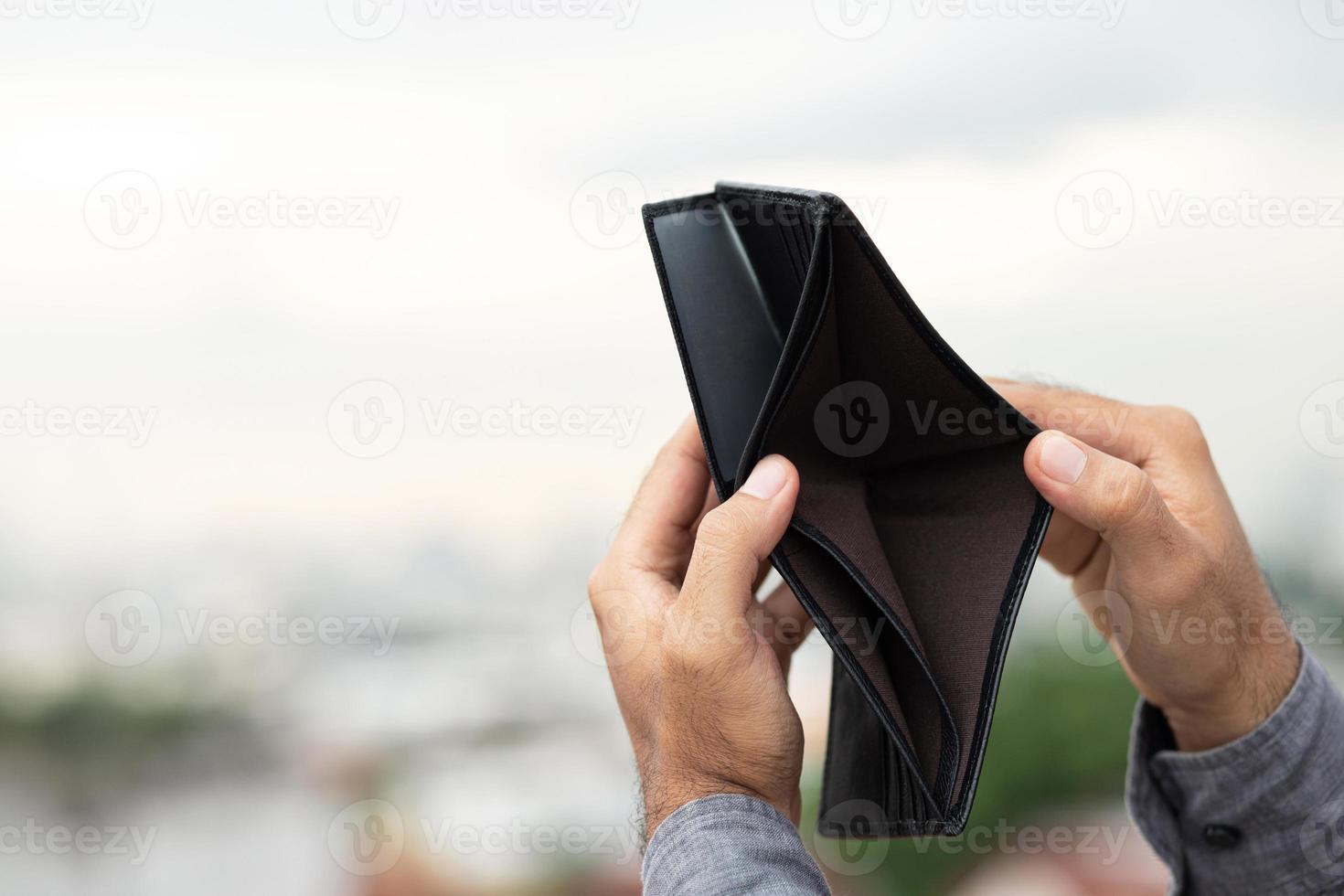 An Empty wallet in the hands of a young man photo