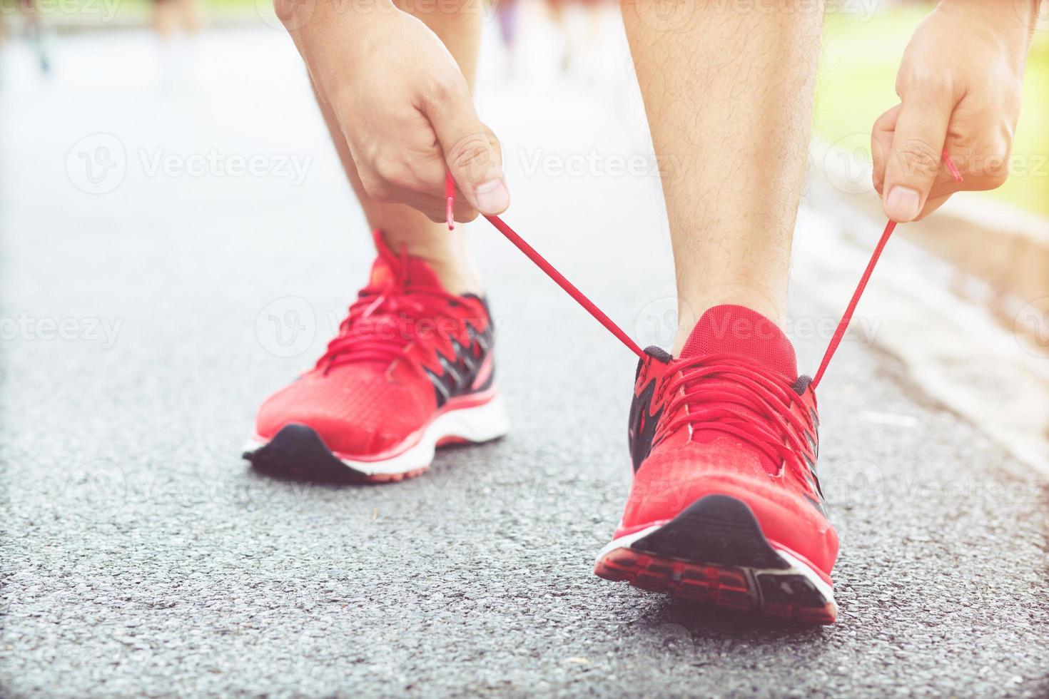 Running shoes. Barefoot running shoes closeup. male athlete tying laces for jogging on road. Runner ties  getting ready for training. Sport lifestyle. photo