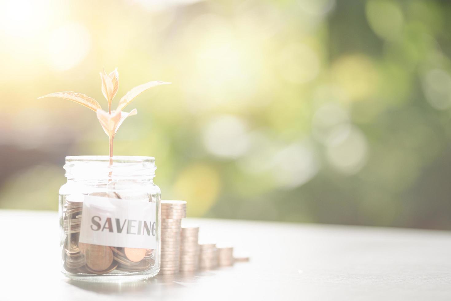 Message in a piece of paper and coins in a glass jar, stacked coins, savings ideas, financial growth, retirement preparations, creating spending habits, investing in financial assets. photo